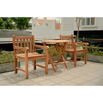 Teakhouten tuinset bestaande uit twee klassieke Windsor stoelen en een ronde, inklapbare tuintafel (Ø 80cm), opgesteld in een sfeervolle tuin.