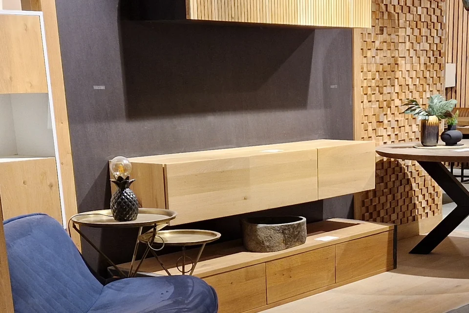 Houten wandopstelling met lage kast in de showroom van Teakea
